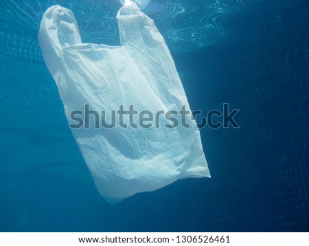 Plastic bag floating into the water. Polluted enviromental. Recycle garbage                 
