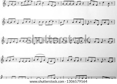 Sheet with music notes as background, top view