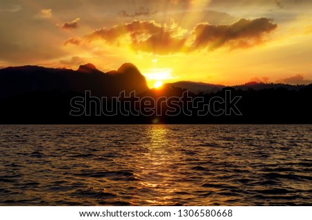 Nice sunset over sea and mountains for background with soft focus.