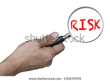 risk concept - hand with magnifying glass (with clipping path)
