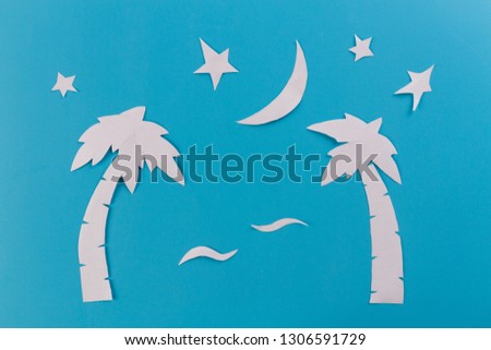 paim trees at night. paper cut on blue background