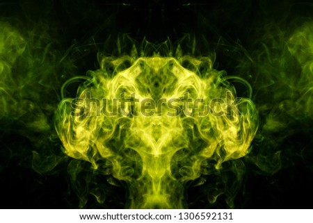 Mocap for cool t-shirts. Thick colorful green smoke  in the form of a monster on a black isolated background. Background from the smoke of vape.
