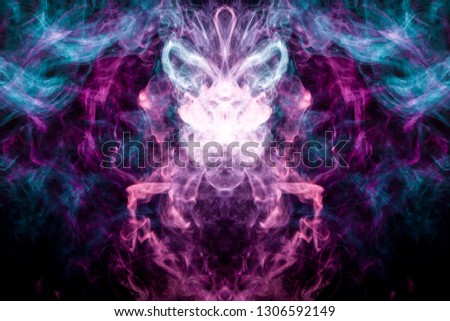 Fantasy print for clothes: t-shirts, sweatshirts.  Colorful pink and blue smoke in the form of a skull, monster, dragon on a black isolated background. Background from the smoke of vape

