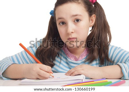 Beautiful girl is drawing with color pencils isolated in white