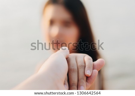Asian woman holding man hand,Select focus. 