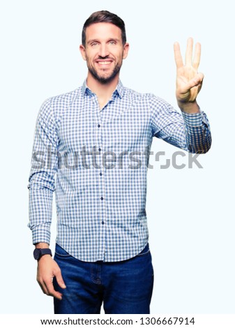 Handsome business man with blue eyes showing and pointing up with fingers number three while smiling confident and happy.