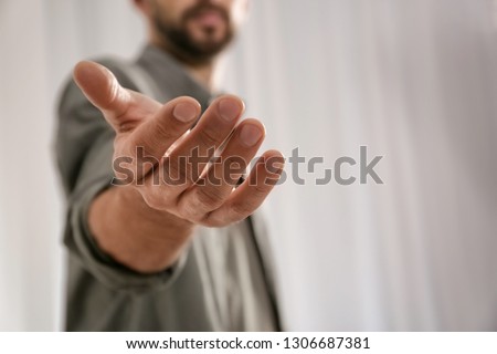 Man giving hand to somebody, closeup with space for text. Help and support concept Royalty-Free Stock Photo #1306687381