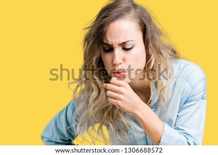 Beautiful young blonde woman over isolated background feeling unwell and coughing as symptom for cold or bronchitis. Healthcare concept.