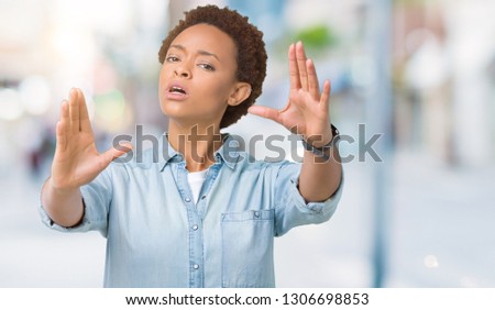 Young beautiful african american woman over isolated background Smiling doing frame using hands palms and fingers, camera perspective