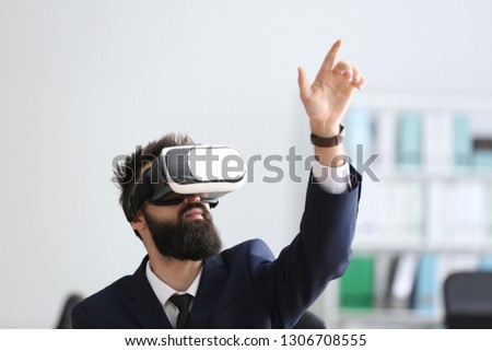 Businessman wearing virtual reality glasses in office