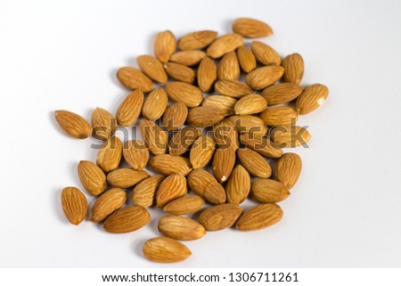 handful of almonds on white background