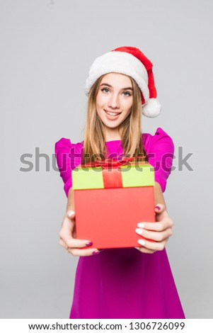 Portrait of a woman in dress holding gift box isolated on a white background