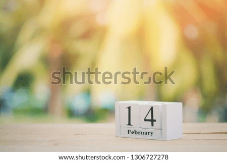 close up wooden calendar on old wood table, nature copy space background for text, 14 february, countdown to holiday season, happy valentine's day concept, vintage tone