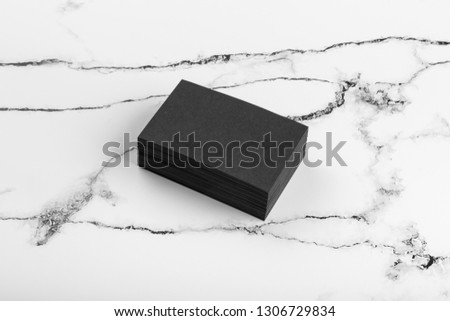 Photo of black business cards on white marble. Template for branding identity isolated on marble background. For  presentations and portfolios marble premium luxury mock-up. Business Card isolated 