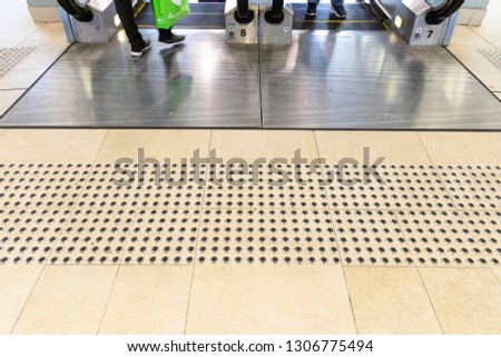 Metal floor tactile to guide vision impaired person at shopping mall in Hong Kong