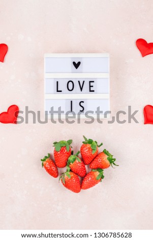 Creative Valentine Day romantic concept composition flat lay top view love holiday celebration with lightbox red heart strawberries pink background copy space Template greeting card text social media