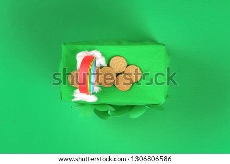 DIY leprechaun trap with gold coins, rainbow and green ladder St Patricks Day background. Gift Idea, decor Saint Patricks Day. Step by step. Child kid craft process. Top view. Irish holiday.