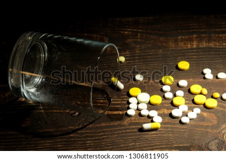 Depression concept. a glass with water and a tablet on a wooden brown table. place for text.
