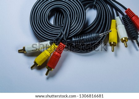 Two hanks of cables with multi-colored plugs a tulip. White monophonic background.