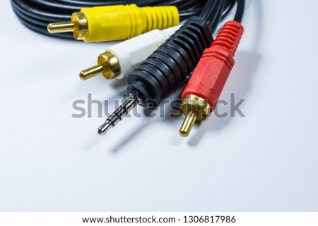 Two hanks of cables with multi-colored plugs a tulip. White monophonic background.
