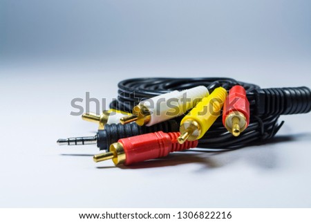 Hank of cables with multi-colored plugs a tulip. Black cord. White monophonic background. 