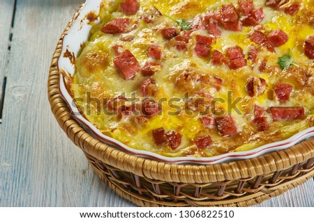 Twice Baked Potato Casserole, Smash the potatoes with a potato masher. Add the cheese, seasoned salt,Cheddar , sour cream, milk, butter, Royalty-Free Stock Photo #1306822510