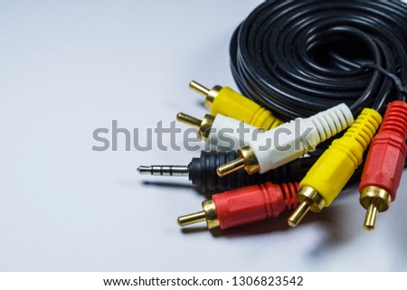 Hank of cables with multi-colored plugs a tulip. Black cord. White monophonic background. 