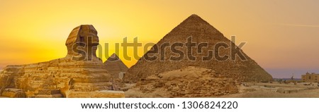 Sphinx against the backdrop of the great Egyptian pyramids. Africa, Giza Plateau. Royalty-Free Stock Photo #1306824220