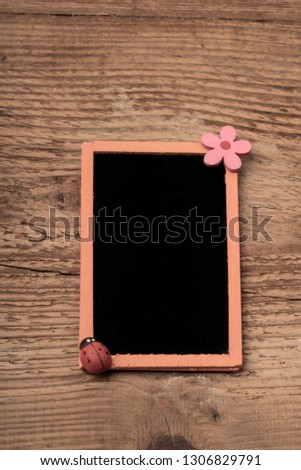 an orange chalkboard on wooden surface with copy space