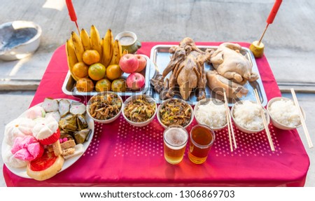 Food on the table for gods worshiping Chinese beliefs, consisting of chicken, duck, fried rice, rice, tea, fruit, various desserts in the China New Year.