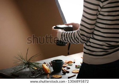 Female photographer working in professional studio