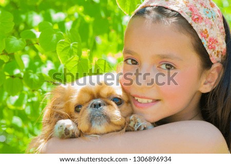 Little girl holding her puppy - Stock image