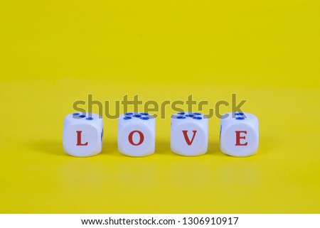 Love text on dice with color background.