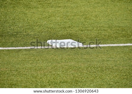close up of base on baseball field on the stadium