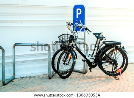 Locked bicycle at bicycle parking in Bangkok, Thailand.
