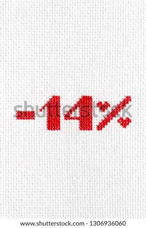Discount to Valentine's Day. The inscription "-14%" is embroidered with red threads on white fabric.
