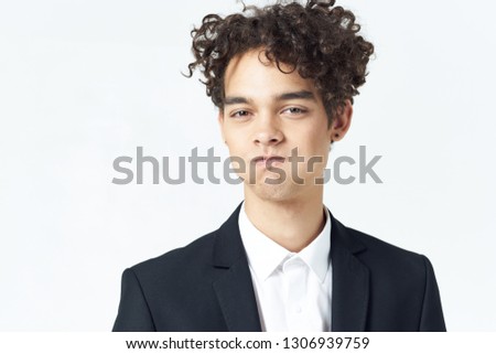Handsome elegant guy in a suit on a bright isolated background office worker