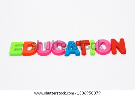 "EDUCATION" Word spelled out in plastic colorful alphabet on white background. 