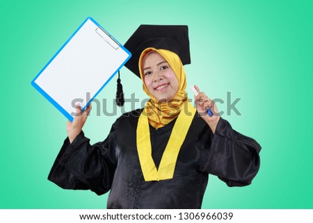 Beautiful Asian Female graduate student holding a clipboard, Education Concept