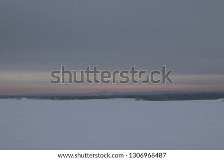 beautiful winter landscape. the trees are covered with hoarfrost. snow-covered hills and a majestic sky of pink. the sun breaks through the clouds