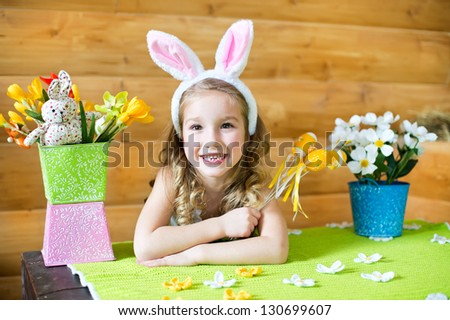 Happy girl with easter bunny ears celebrates holiday emotionally