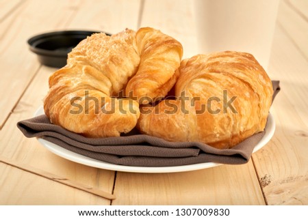 fresh baked croissants on wooden table