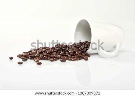 Coffee beans in coffee cup isolated on white background
