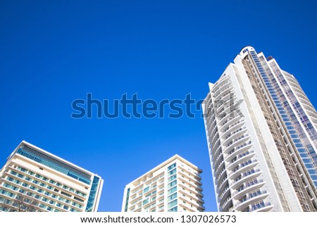 Three hotels buildings on a sunny day with a blue sky