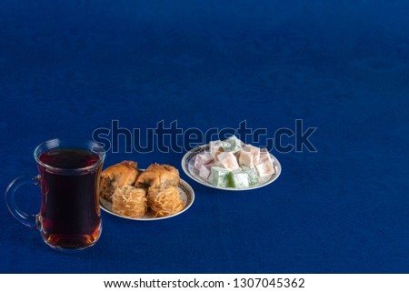 Eastern sweets baklava and Turkish Delight on blue table