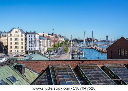 Helsinki, part of the city along the coast, commercial docks, roofs of buildings.