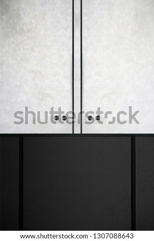 Refined photo of wall panels resembling wardrobe with semitransparent matte glass doors having marble texture. Abstract black and white material or architectural background in minimalism style.