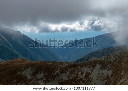 panoramic view of Tatra mountains in slovakia. mist and cloud covered mountain peaks in colorful autumn