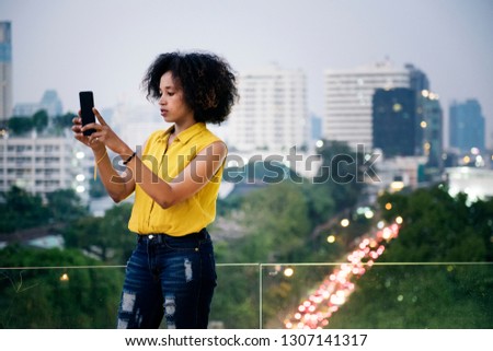 Young woman taking a photo in the cityscape