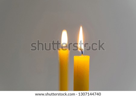 Worm atmosphere near the burning yellow candle.